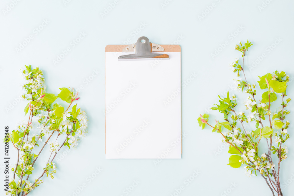 Mockup clipboard with with spring flowers on a light background