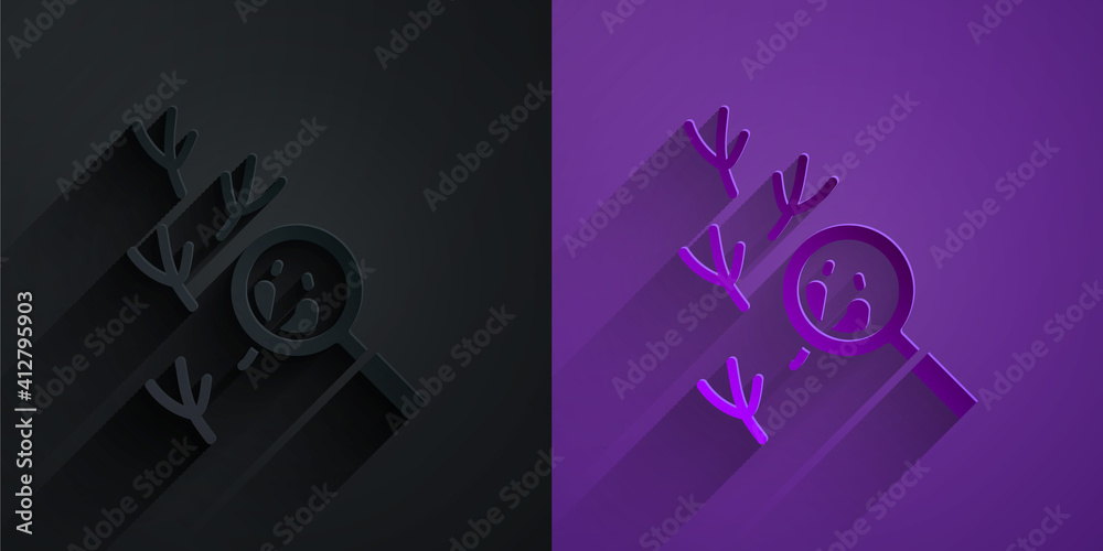 Paper cut Bird footprint under magnifying glass icon isolated on black on purple background. Animal 