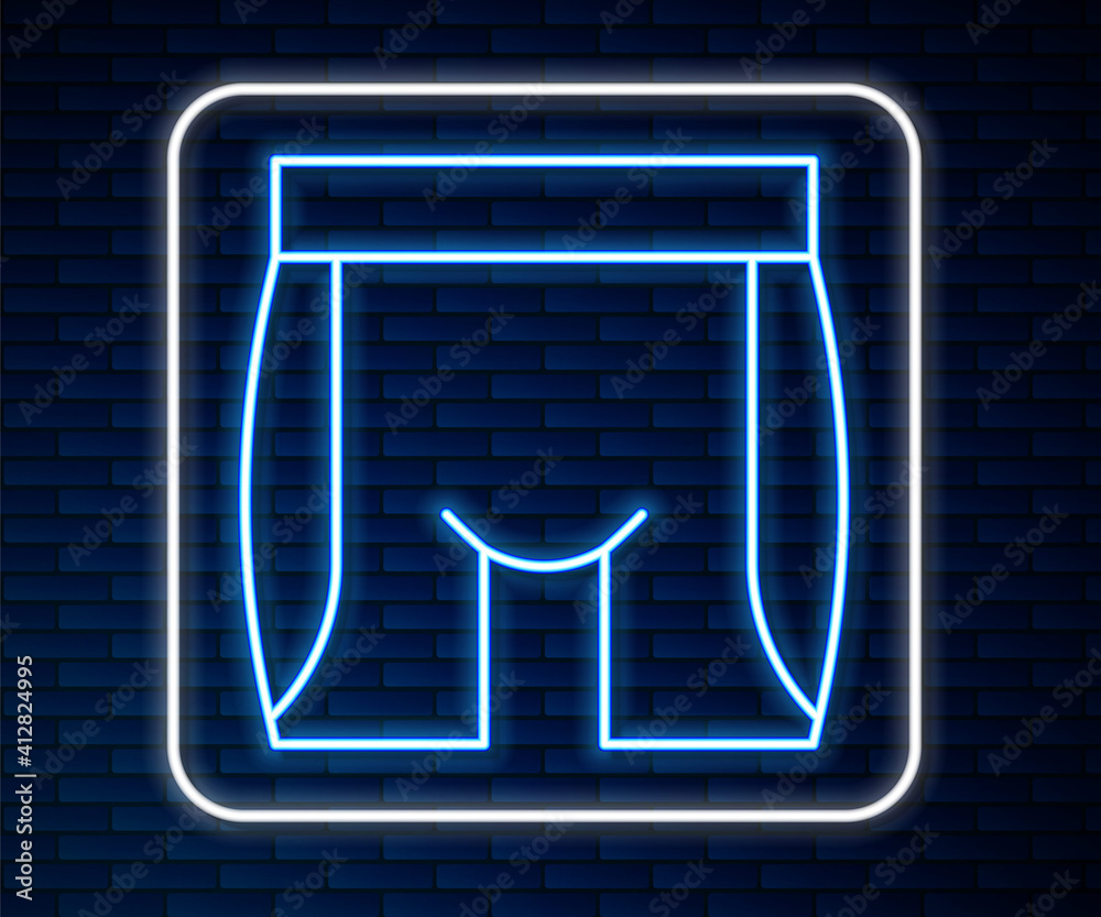 Glowing neon line Cycling shorts icon isolated on brick wall background. Vector.