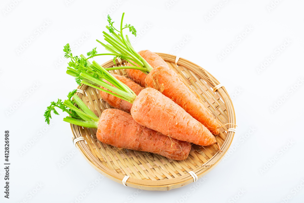 Fresh carrots in a pot on white background