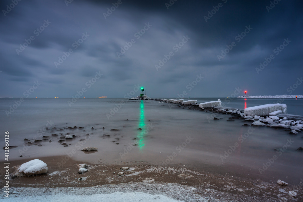 Amazing landscape of frozen beach of baltic Sea in Gdansk at dusk, Poland