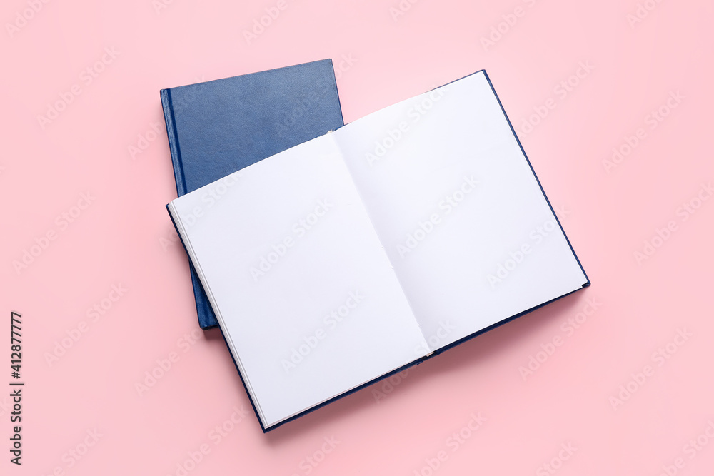 Blank books on color background