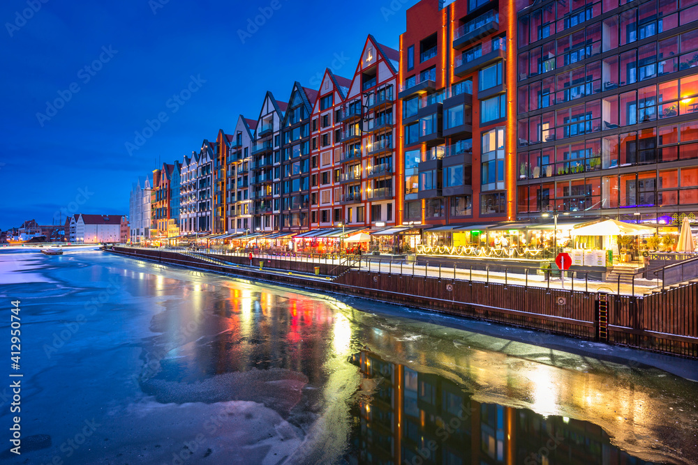 The granaries island over Motlawa river at snowy dusk, Gdansk. Poland