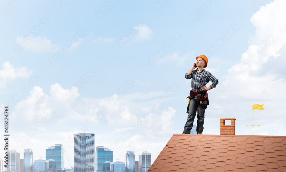 Attractive woman in workwear and hardhat