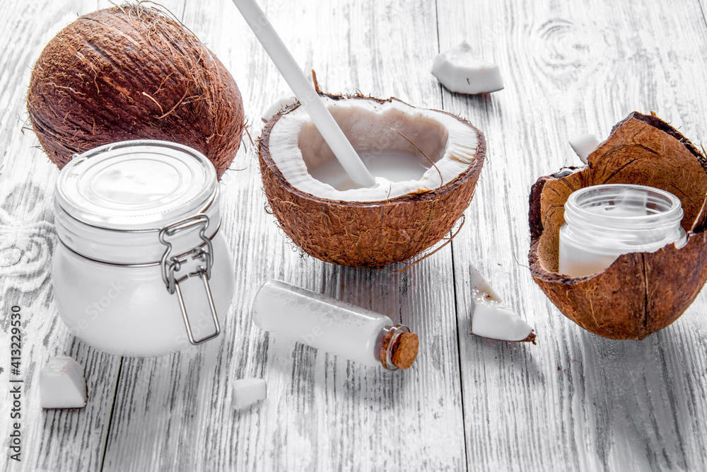 organic cosmetics with coconut on wooden background close up