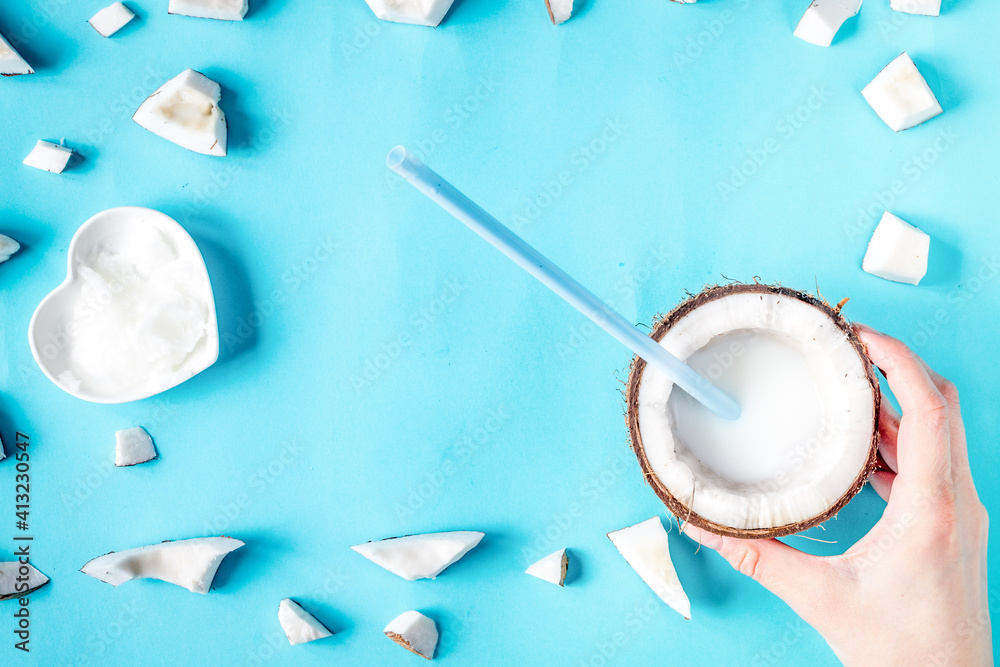 concept organic cosmetics with coconut on blue background top view