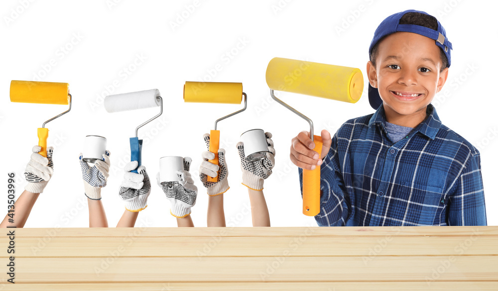 Cute African-American boy with paint roller on white background