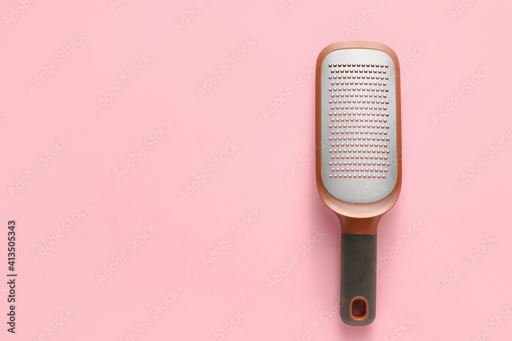 Metal grater on color background