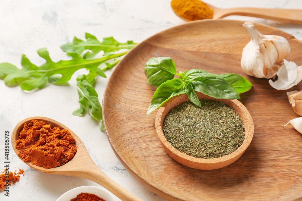 Bowl and spoons with different spices on light background, closeup