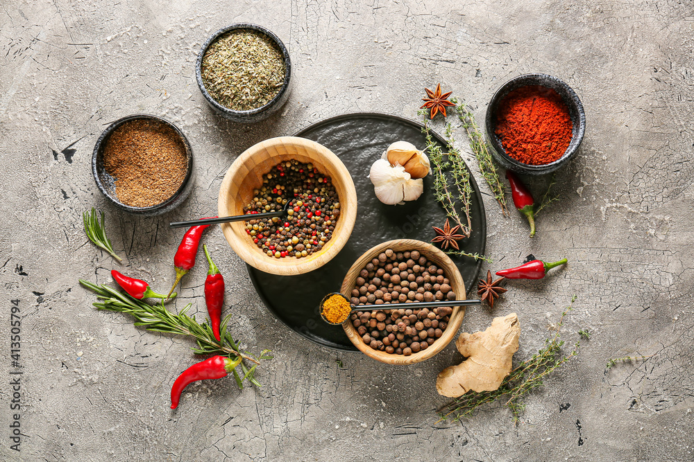 Bowls with different spices on dark background