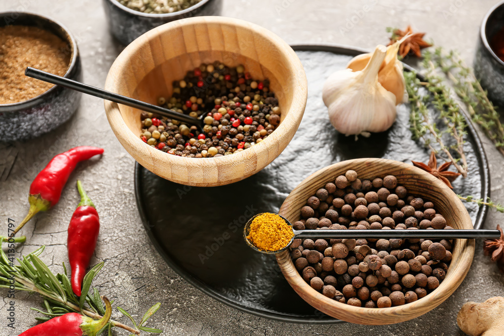 Bowls with different spices on dark background, closeup