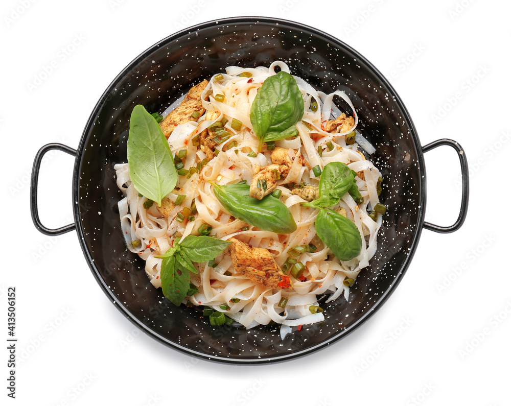 Frying pan with tasty noodles and chicken on white background