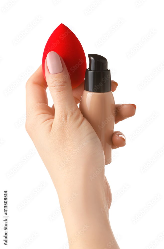 Hand with makeup sponge and concealer on white background