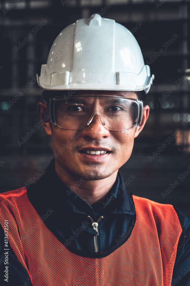 Young factory job worker or engineer close up portrait in manufacturing factory . Industry and engin