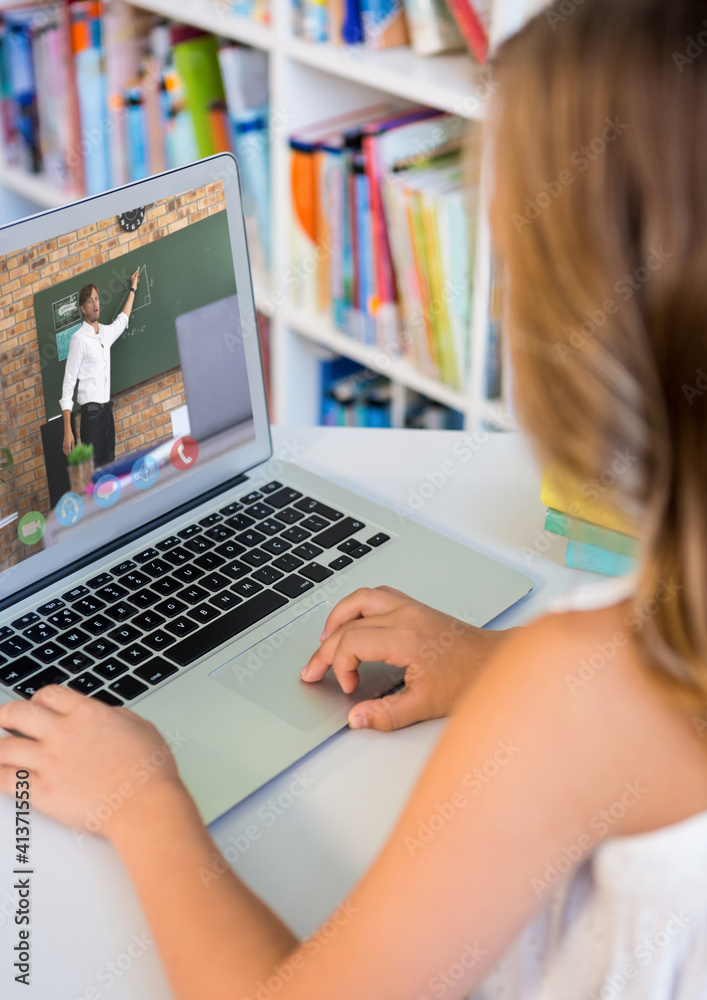 Female student having a video call with male teacher on laptop at library