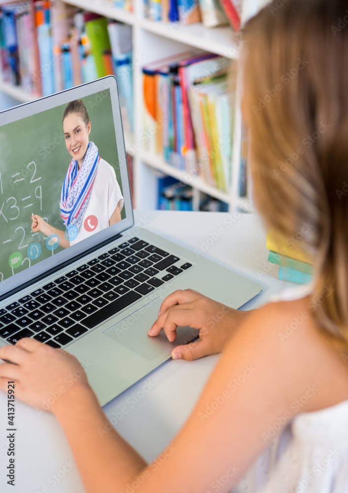 Female student having a videocall with female teacher on laptop at home