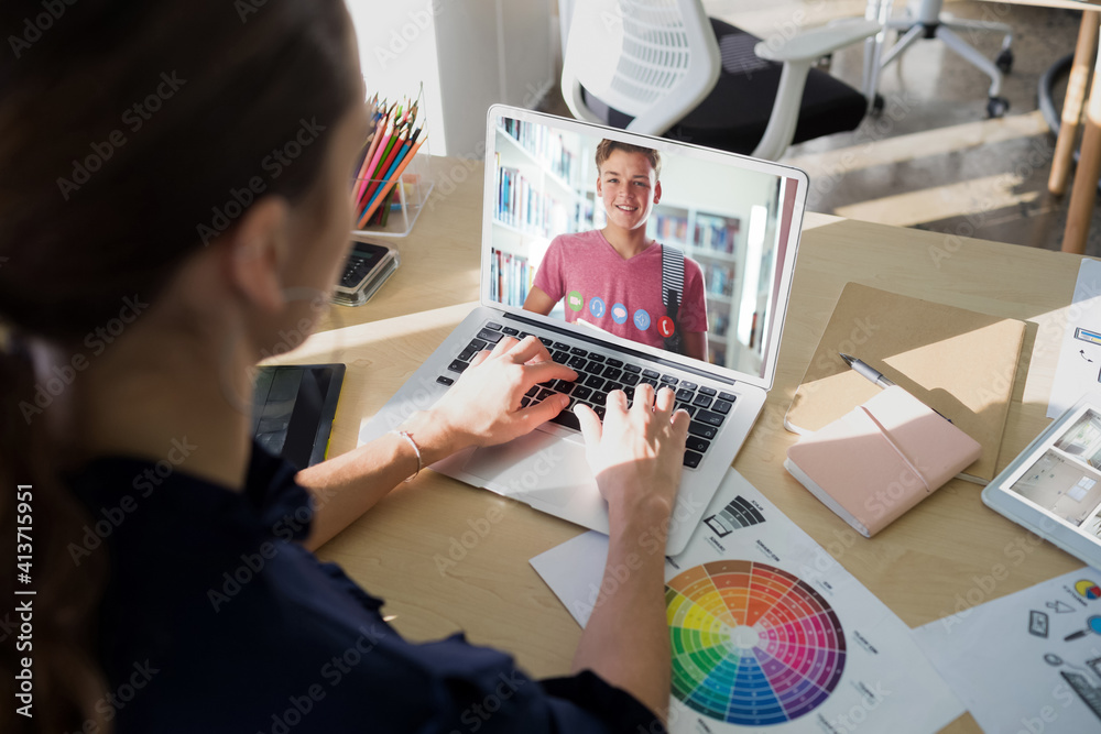 Female teacher having a videocall with male student on laptop at home