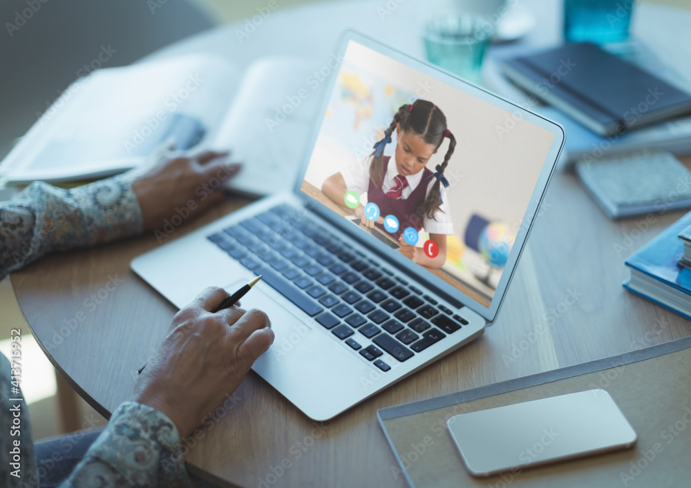 Female teacher having a videocall with female student on laptop at home