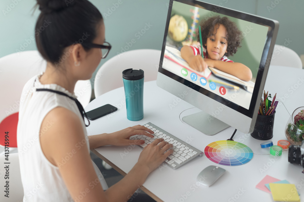 Female teacher having a videocall with male student on computer at home