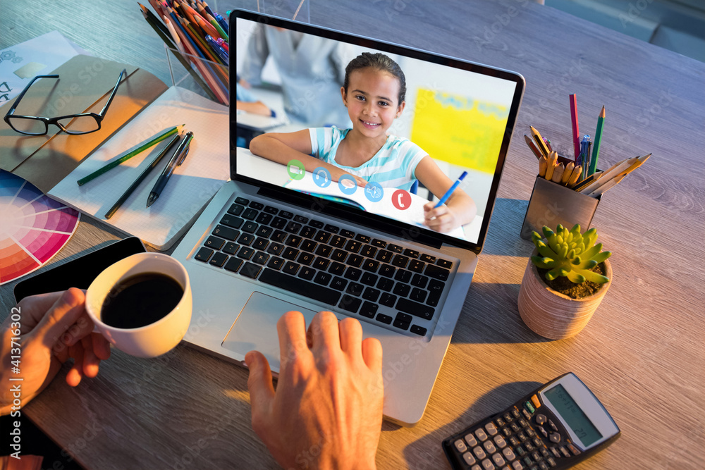 Mid section of teacher having a video call with female student on laptop at school