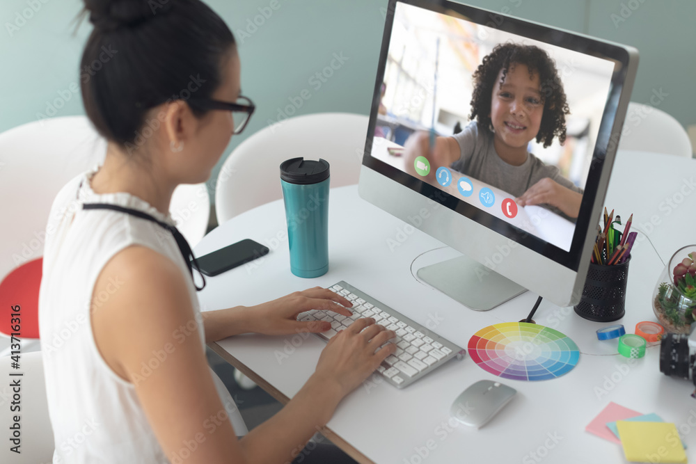 Female teacher having a video call with male student on computer at school