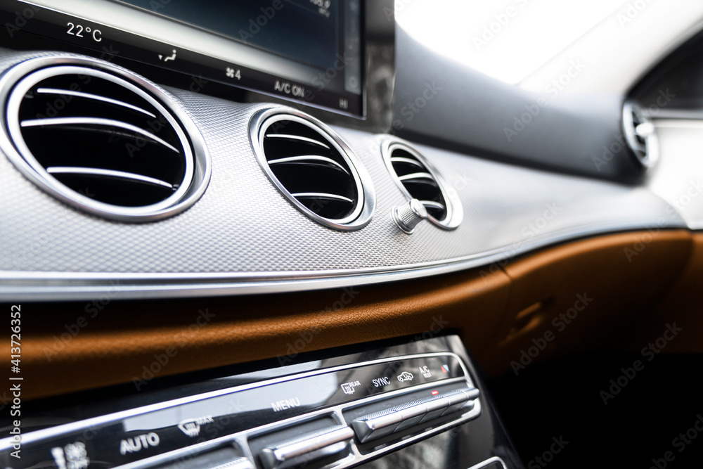 Brown luxury modern car Interior. Steering wheel, shift lever and dashboard. Detail of modern car in