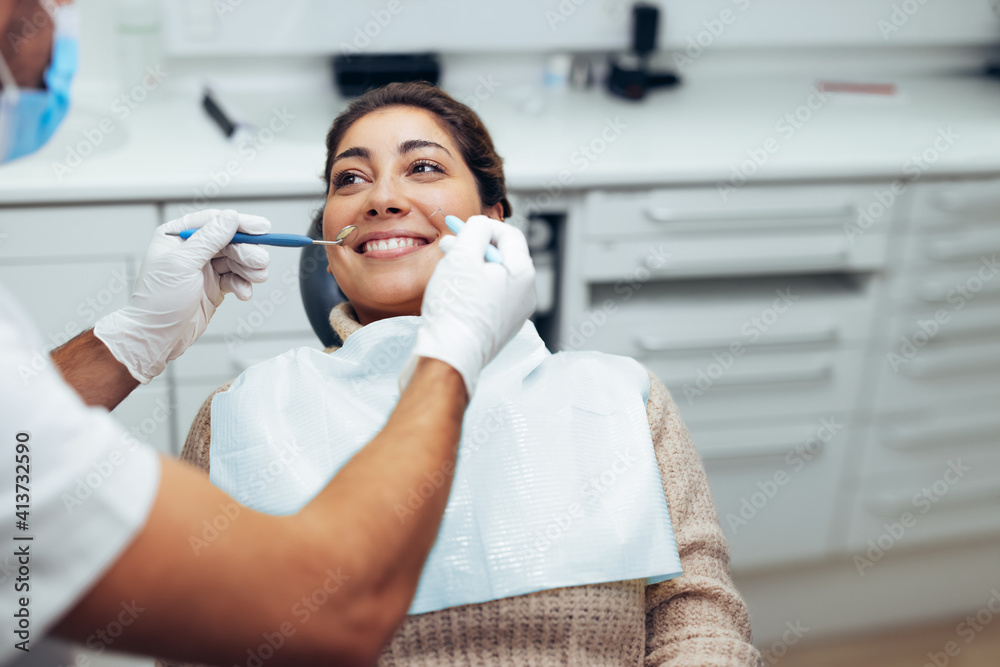 Woman getting a dental treatment at dentistry