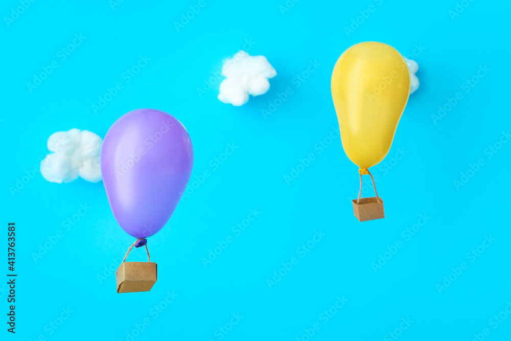 Creative hot air balloons on color background