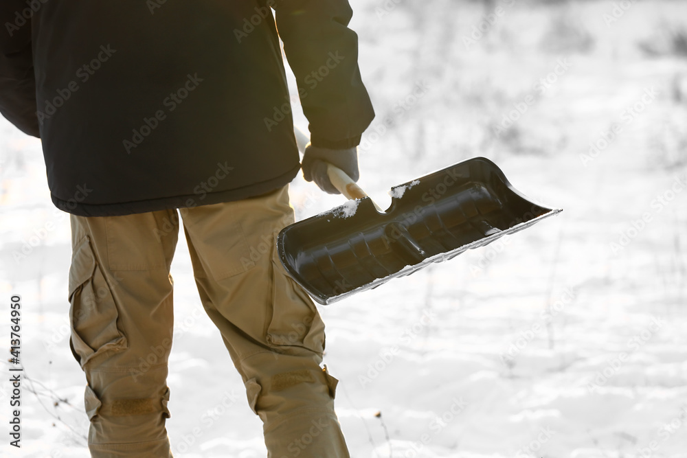 Man removing snow with shovel