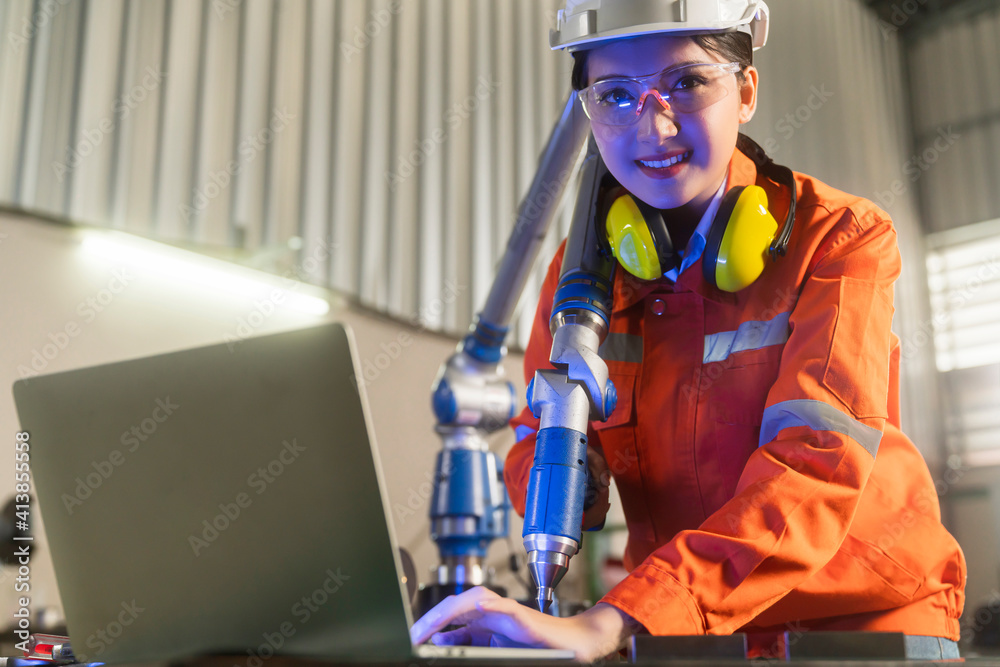 asian female engineer specialist with Measuring machine with a manipulator arm.Three-dimensional coo