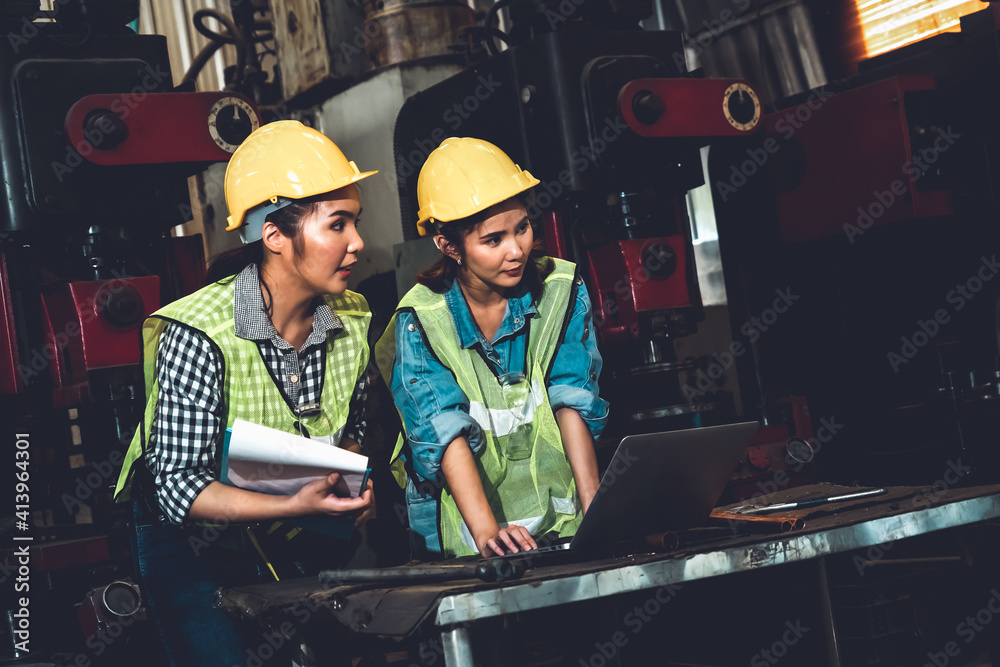 Factory job workers working and discussing manufacturing plan in the factory . Industry and engineer