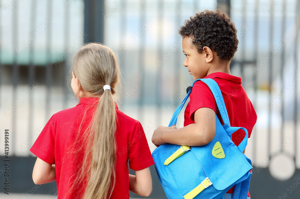 Cute little pupils going to school