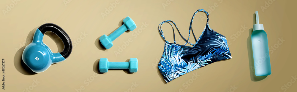 Fitness theme with dumbbells and a sportswear - flat lay