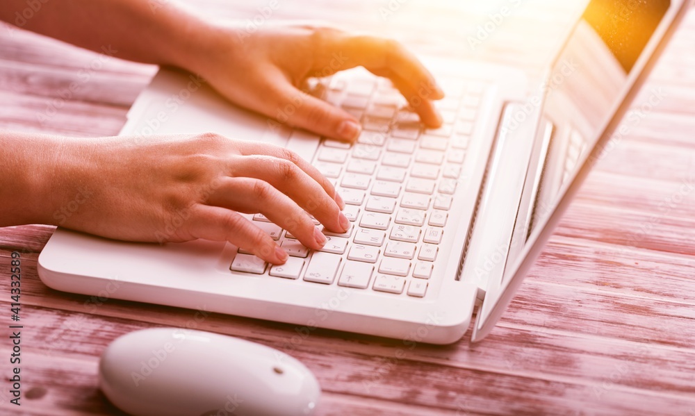 Human hands working on laptop on office desk