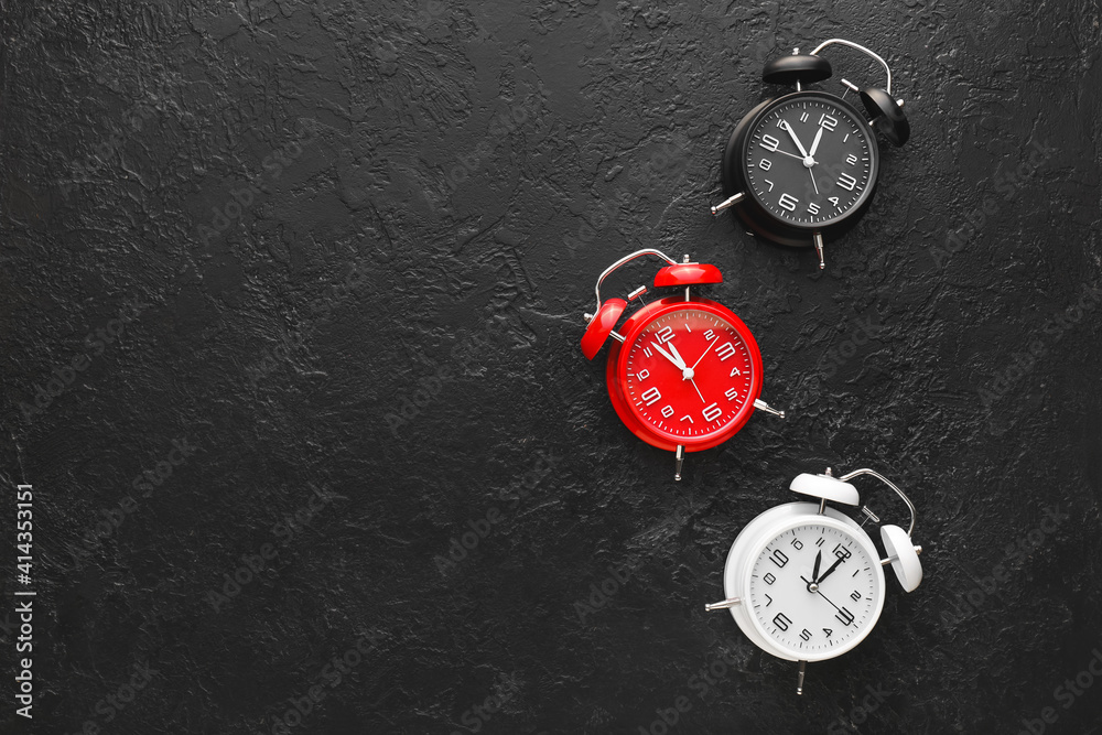 Alarm clocks on black background