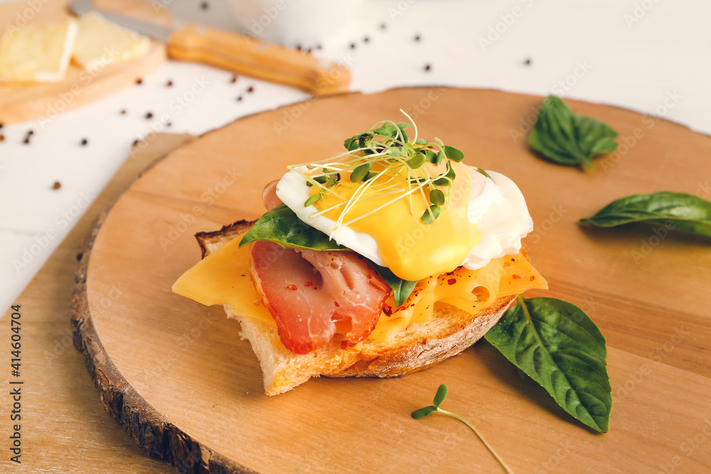 Tasty sandwich with florentine egg and bacon on light background, closeup