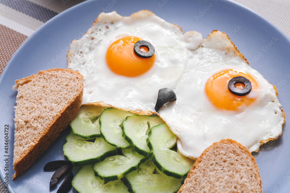 Creative breakfast for children with eggs, toasts and fresh vegetables on table, closeup