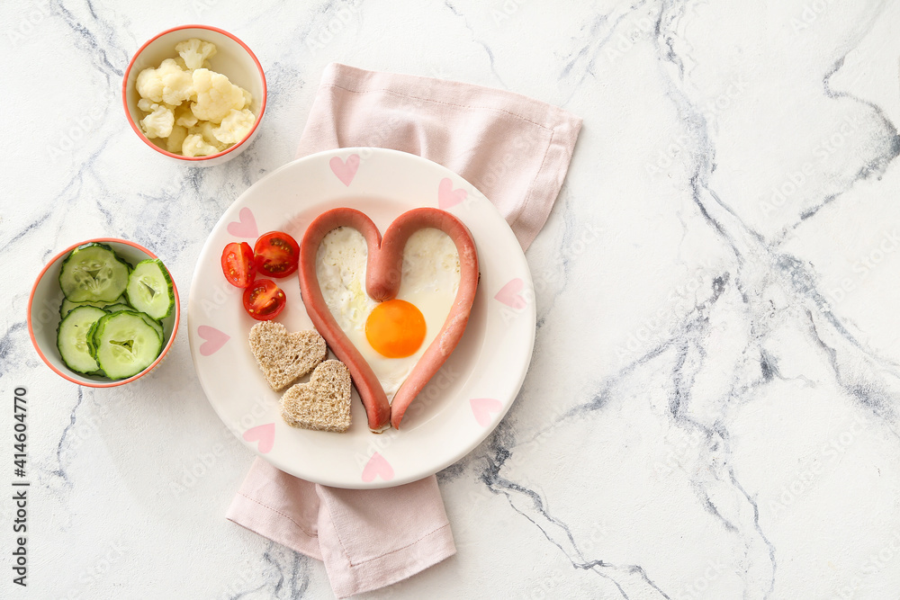 Creative breakfast for children with egg, sausage and fresh vegetables on light background