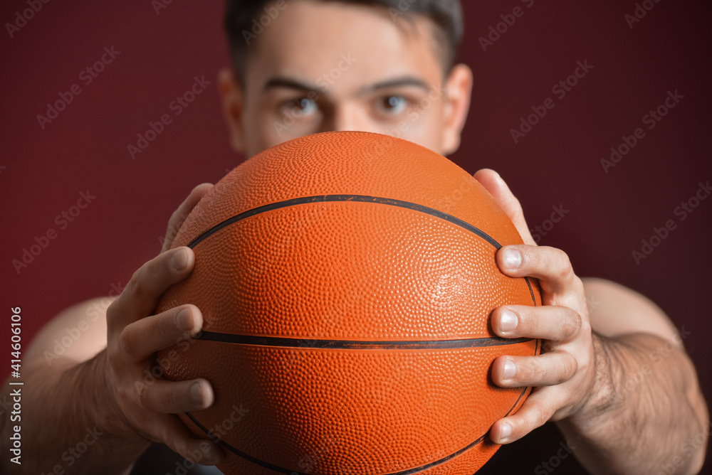 Male basketball player on dark color background, closeup