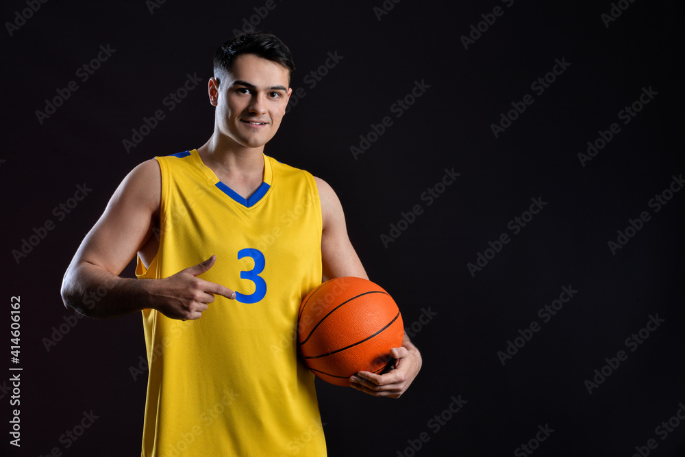 Male basketball player on dark background