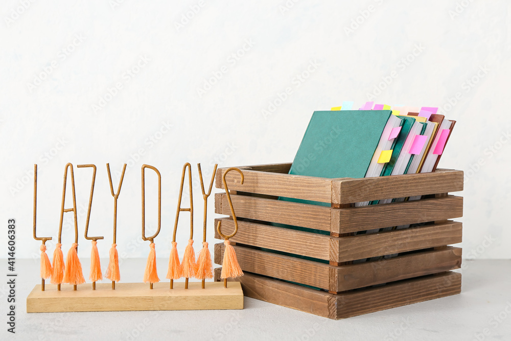 Wooden box with many books on table