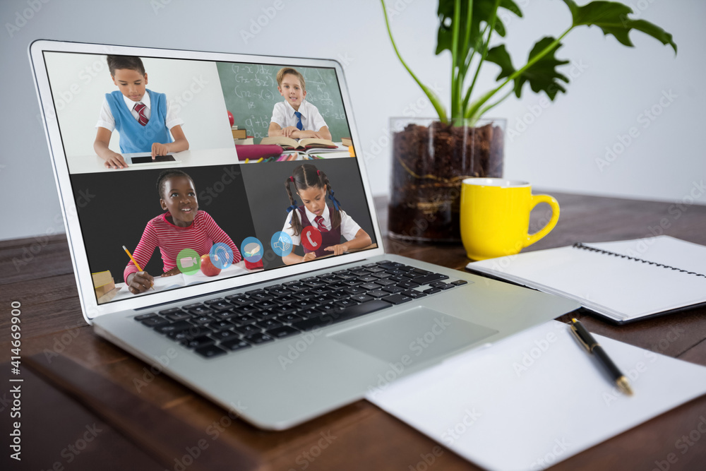 Webcam view of multiple students on video call on laptop on wooden table