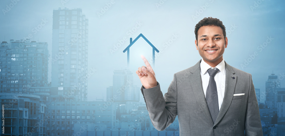 Handsome businessman pointing at something on white background