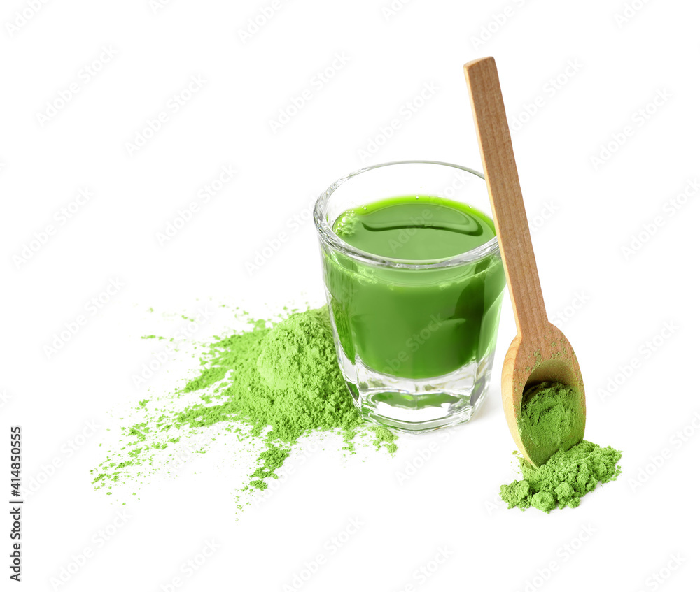 Glass with fresh wheatgrass juice and powder on white background