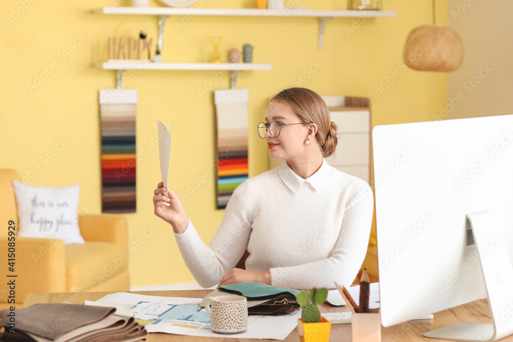 Female interior designer working in her office