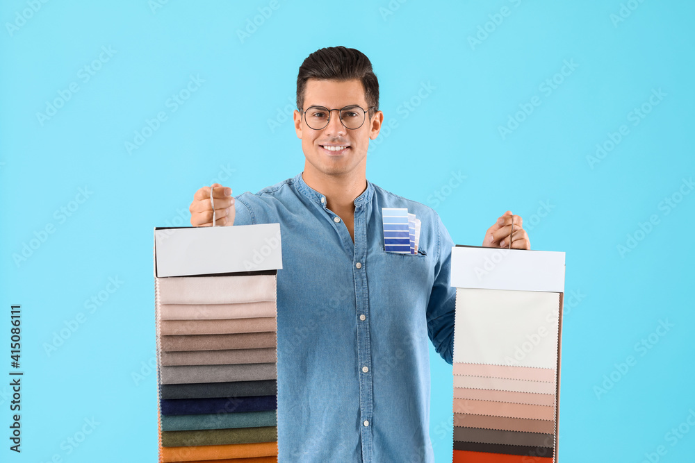 Male interior designer on color background