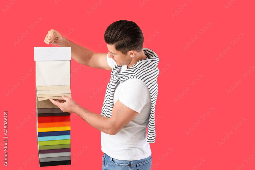 Male interior designer on color background