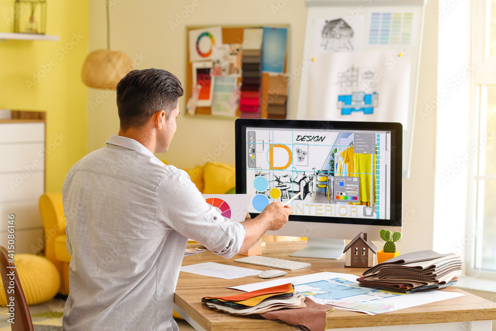 Male interior designer working in his office