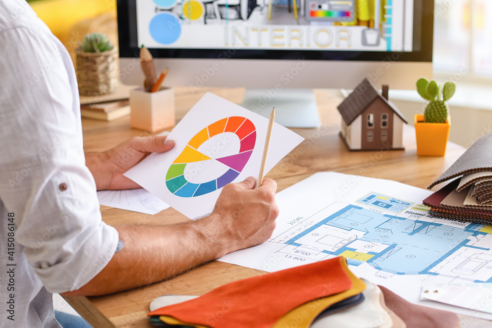 Male interior designer working in his office