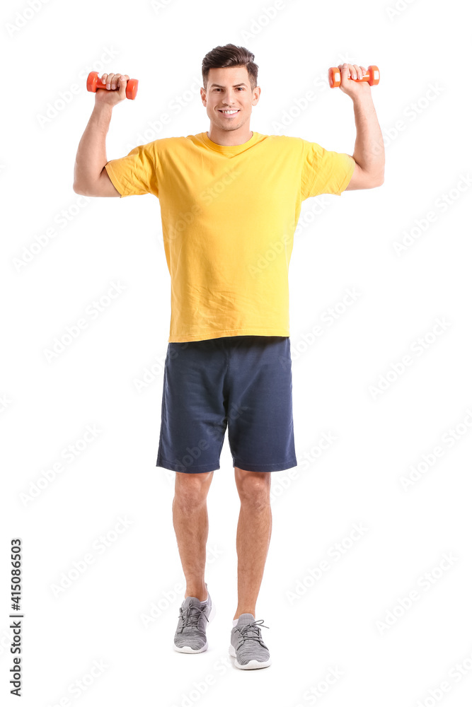 Sporty young man training with dumbbells on white background